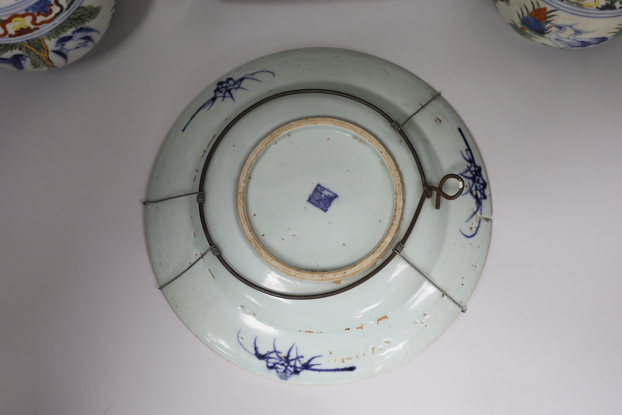 A Chinese style armorial bowl, pair of Chinese clobbered vases and a blue and white plate